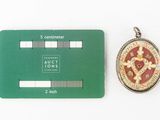 a green card with a picture on it next to a coin