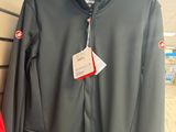 two men ' s jackets hanging on a wall in a store