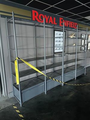a display case in the middle of a room with a yellow ribbon