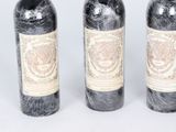three bottles of wine sitting next to each other on a table