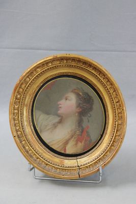 pair of miniature portraits of a woman and a man in a gold frame