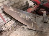 a red tractor that is sitting in the dirt
