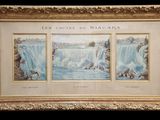 une peinture représentant une cascade, dans un cadre doré