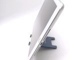 a tablet computer sitting on a stand on a white surface