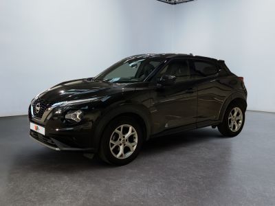 the black nissan suv is parked in a large room