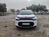 the front of a white citrole parked in a parking lot