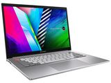 the laptop is open on a white surface with a colorful background