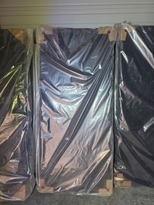 three pieces of plastic wrapped up in a room