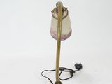 an antique brass table lamp with a glass shade on top of it