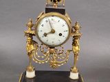 a gold clock with a crown on top of it