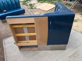 a blue couch that is sitting on a concrete slab
