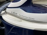 a close up of a blue and white steam iron