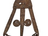 an old rusty iron object with a metal handle on a white background