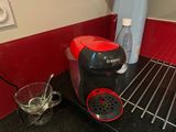 a red and black coffee maker sitting on a counter