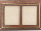 an old picture frame with a picture of two windows in it