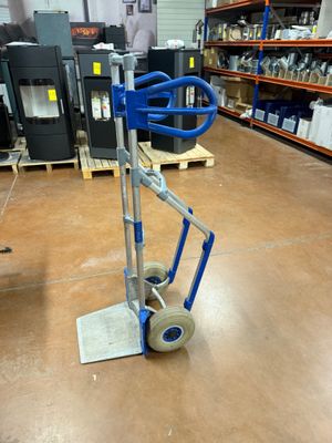 a hand truck with a blue handle in a warehouse