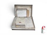 an open suitcase with papers inside of it on a white surface