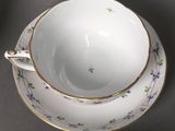 a tea cup and saucer on a saucer on a table