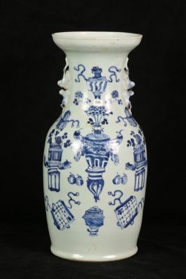 a blue and white vase sitting on a black surface