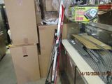 several skis and ski poles are stacked on a shelf in a store