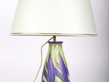 a lamp that is sitting on a table next to a lamp shade