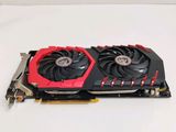 a close up of a red and black graphics card on a white surface
