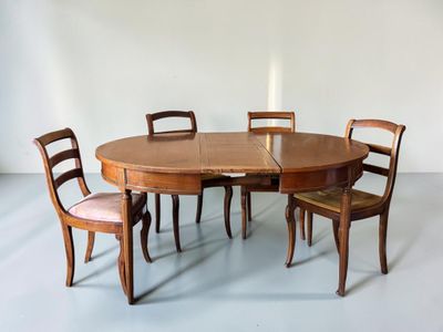 a table with four chairs and a candle on top of it
