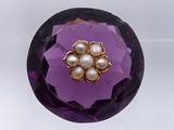 an image of a close up of a purple object with pearls on it