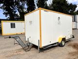 a white trailer with a yellow trailer attached to it