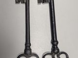 two old keys that are sitting on a table