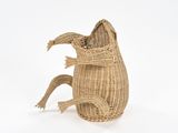 a rattan basket with a large lizard on it