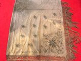 an old table runner with fringes on a red carpet