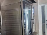 a large stainless steel oven in the middle of a kitchen