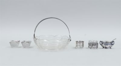 an assortment of silver and glass objects including a basket, spoon, and other items
