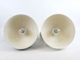 pair of white lamps on a white surface with a white background