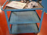 a blue cart with a piece of paper on top of it