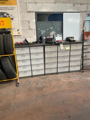 a yellow cart with tires on it in a garage