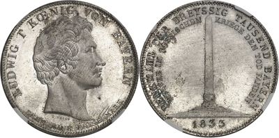 a close up of a silver coin with a statue on it