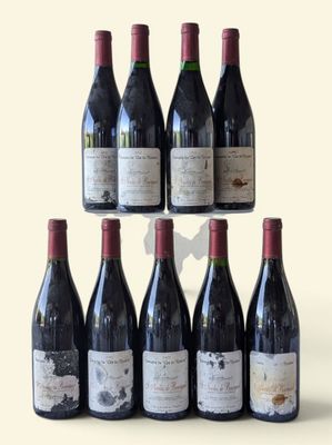 several bottles of wine are arranged in a pyramid on a table