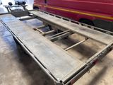 a trailer with a table attached to it in a garage