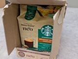 a box of coffee sitting on a table with a cup of coffee in it