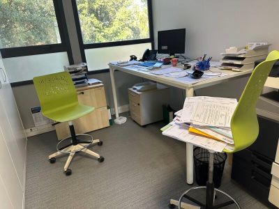a desk with a chair and a computer on it
