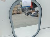 a mirror that is sitting on a table in a room