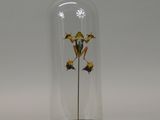 a glass bellow with a flower inside of it