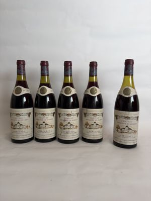six bottles of wine are lined up in a row on a table