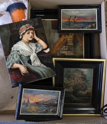 une boîte remplie de tableaux et de photos posée sur une table