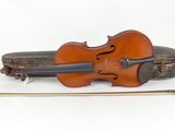 a violin that is sitting next to a violin case