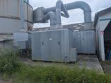 a large industrial air conditioner in the middle of a field