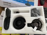 a box with a keyboard, mouse, headphones, and other items in it