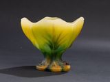 yellow and green glass vase on a black surface